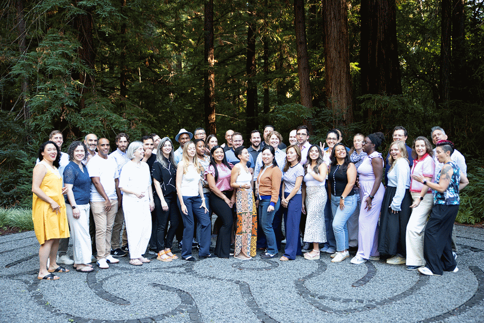 Animated GIF of a group of people dancing in place in front of trees